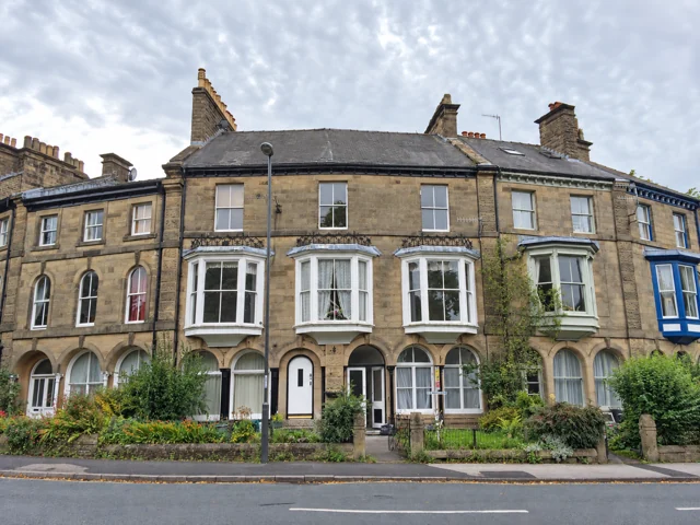 Stone terraced houses with bay windows in Buxton