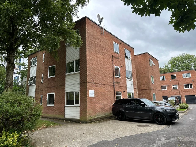 Brick apartment buildings with shared parking in Salford